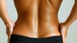 © imagineRbc - A woman stands with her back turned, highlighting her toned physique and smooth skin. The setting is minimalistic and well-lit, contributing to a serene atmosphere