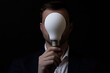 © Maxim Borbut - A light bulb-headed person dressed in a dark suit represents ideas and creativity.