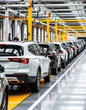 © Maryna - Modern SUVs move along automated production line in large factory. Automated manufacturing process ensures efficiency, high quality. Cars white, dark gray. Conveyor system supports assembly line.