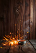 © SusDmi - Abstract wood texture with sparks flying creating a dynamic backdrop for culinary products emphasizing heat and energy, glowing neon, with white tones