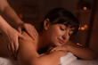 © New Africa - Young woman receiving massage in spa salon