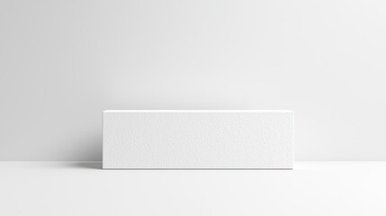 Wall Mural - A minimalist white block on a clean surface against a plain wall, suggesting simplicity.