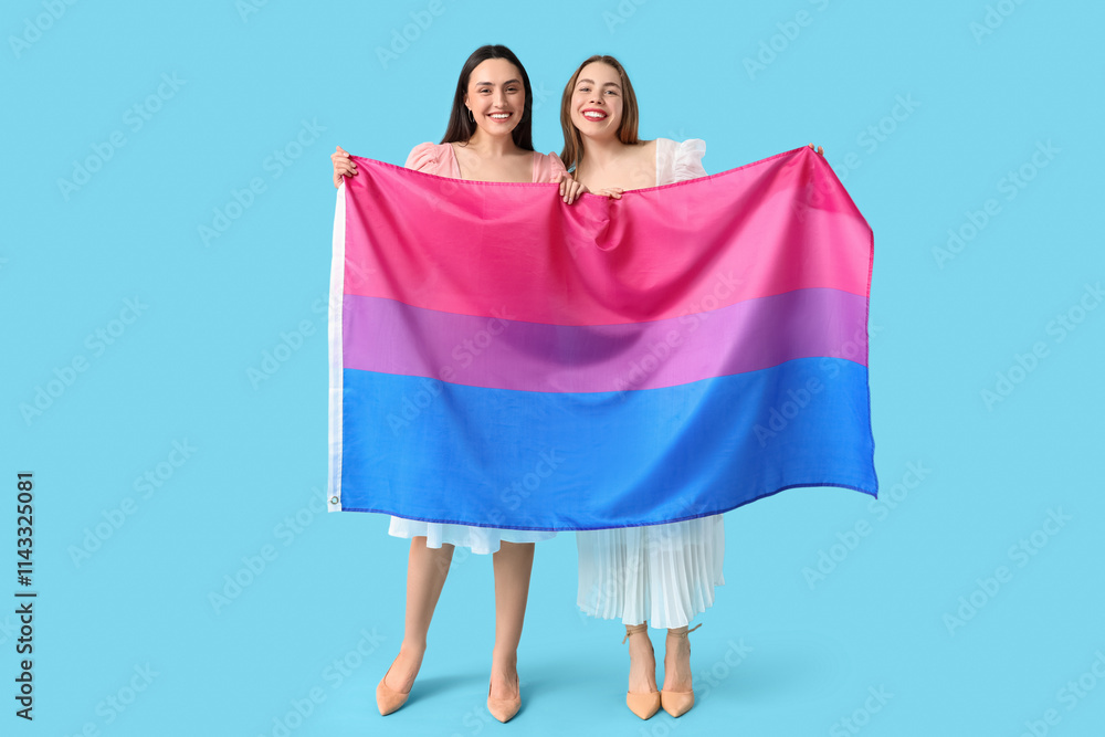 Beautiful young lesbian couple with Bisexual flag on blue background