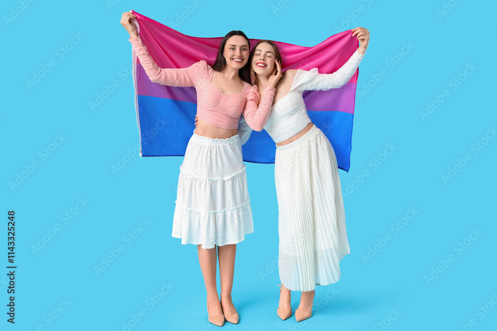 Beautiful young lesbian couple with Bisexual flag on blue background
