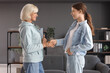 © Pixel-Shot - Female psychologist with teenage girl shaking hands in office