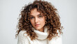 © Nea - Beautiful woman in a white sweater on a white background - Curly hair woman