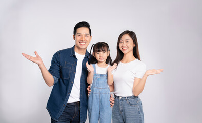 portrait  of a happy asian  family posing on a white background