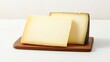 © A4719 - A wooden board with two types of cheese, one white and creamy, the other dark and aged, showcasing their textures and colors.