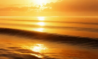 Wall Mural - golden sunset over shimmering ocean waves under glowing sky