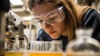© Kamran - a researcher wearing safety goggles, analyzing liquid samples in a high-tech lab, focused on examining the samples under a microscope, with advanced lab equipment and glowing screens, highlighting the