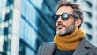 © thanarak - Elegant man wearing cashmere scarf and fitted wool suit in urban setting fashion photography nature-inspired backdrop close-up view style and sophistication