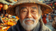 © Darya - Close-up of an elderly Asian man wearing a traditional hat and beard