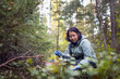 © Johnér - Mid adult woman hunting mushroom in forest