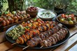 © Khawla - Middle eastern, arabic or mediterranean dinner table with grilled lamb kebab, chicken skewers with roasted vegetables and appetizers variety serving on wooden outdoor table. Overhead view