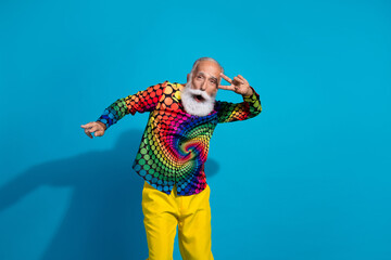 Wall Mural - Photo of funny stylish aged man dance show v-sign eye wear colorful shirt isolated on blue background