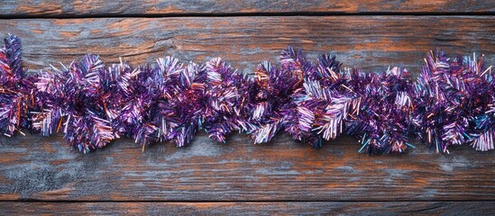 Poster - Holiday decoration flat lay featuring colorful tinsel on rustic wooden table perfect for Christmas and New Year greetings and text space.
