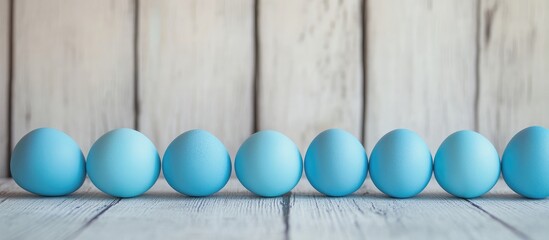 Fototapete - Blue Easter Eggs in a Row on Light Gray Wooden Surface with Space for Text for Holiday Celebrations and Seasonal Greetings