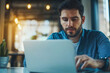 © romanets_v - Young caucasian male working on laptop in modern office setting