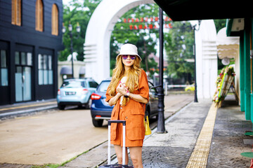 Fashionable Young Woman Waiting on The Sidewalk with Luggage