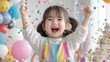 © kinara art design - Joyful toddler girl celebrating with confetti and balloons.