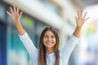 © Road Red Runner - Smiling woman raising hands in celebration during a sunny day outdoors