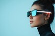 © Odin AI - Stylish woman wearing futuristic sunglasses with neon accents poses against a minimalist background