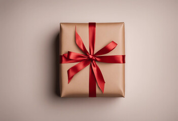 Top view of Christmas gift box wrapped in brown craft paper and red ribbon isolated on white or tran