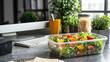 © standret - Healthy lunch box with fresh salad on modern office desk