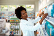 © Davor - Female pharmacist organizing products on store shelf