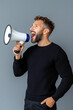© Lucky_jl - man passionately shouting into megaphone, expressing enthusiasm and motivation
