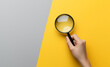 © The - Man hand with magnifying glass. Yellow ray coming from loupe. Conducting check, information search and analysis concept. Spy, accountant, auditor job in abstract style. High quality