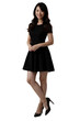 © Flash - A smiling Asian woman in a black dress and heels poses against a plain white background.