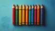 © Meffl - A row of crayons are lined up on a blue background