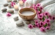 © olegganko - Relaxing spa setting with natural elements showcasing calm ambiance, soft towels, flowers, stones, and soothing