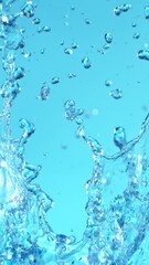 Fototapete - Super Slow Motion of Flying Water Splashes, Isolated on Blue Background. Filmed on High Speed Cinema Camera, 1000fps. Vertical Aspect Ratio.