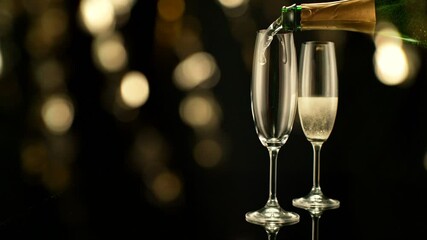 Fototapete - Super Slow Motion of Pouring Champagne Wine on Black Background with Flashing Blur Spot Lights. Filmed on High Speed Cinema Camera, 1000fps.v