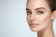 © Margarita Ratatosk - Woman with perfect skin after cosmetic treatment with lifting arrows on her face on light background. Rhytidectomy procedure, facelift surgery, anti age treatment
