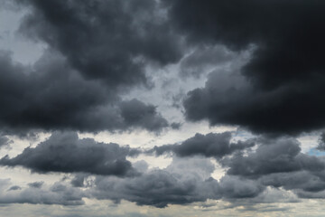 Wall Mural - Epic Dramatic Storm sky with dark grey black cumulus rainy clouds abstract background texture, thunderstorm