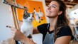 © Pinklife - A joyful artist, accompanied by her attentive cat, paints vibrant artwork, capturing the cheerful bond between human and feline in a cozy studio setting.