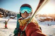 © Pinklife - A smiling skier in reflective goggles takes a selfie while holding skis on a snowy mountain, with a clear sky and distant skiers enjoying winter sports in the background.
