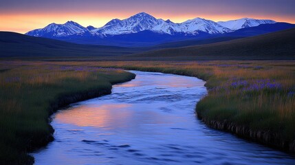 Wall Mural - Serene sunset over a meandering river and snow-capped mountains.