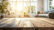 © BerkahStock - Empty wooden table with bright, blurred indoor background.