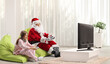 © Ljupco Smokovski - Santa claus playing video games with a teenage girl