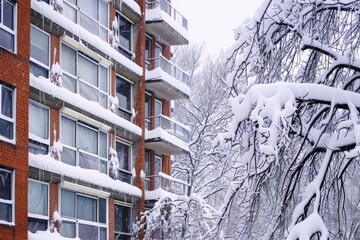 Snow On Building. Modern Apartment Covered in Winter Snow Storm