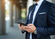© Galeno - male human wears formal suit holding smart phone deliver electronic tickets quickly