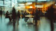© Nathan - A blurred scene of diverse professionals engaged in conversation at a modern workspace.