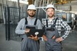 © Serhii - Two engineer worker working together with safety uniform and white helmet to work in industry factory