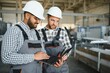 © Serhii - Two workers at a factory for the production of metal plastic windows and doors.
