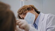 © stockbusters - Experienced dentist examining patient teeth health at dental checkup closeup.