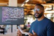 © LifeMedia - A confident man with glasses stands in an office, presenting in front of a screen filled with colorful code, embodying modern technology and communication.